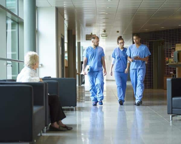 Nurses walk down hallway