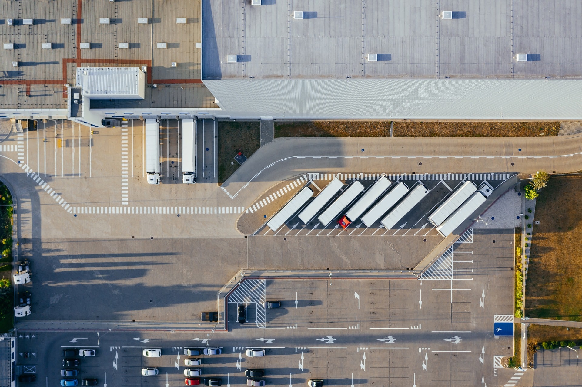Top view of distribution warehouse with semi trucks
